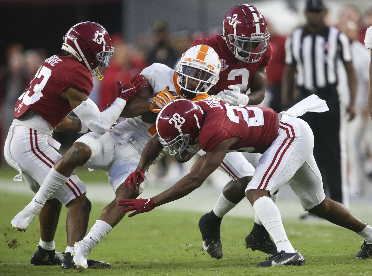 Tennessee Volunteers wide receiver Velus Jones Jr. (1) is stopped by Alabama Crimson Tide defensive back Malachi Moore (13) and defensive back Josh Jobe (28) during the first half at Bryant-Denny Stadium.